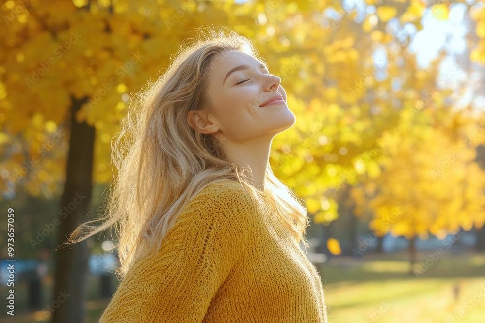 Caucasian woman wearing yellow knitted sweatshirt in autumn park at sunny day Caucasian woman wearing yellow knitted sweatshirt in autumn park at sunny day