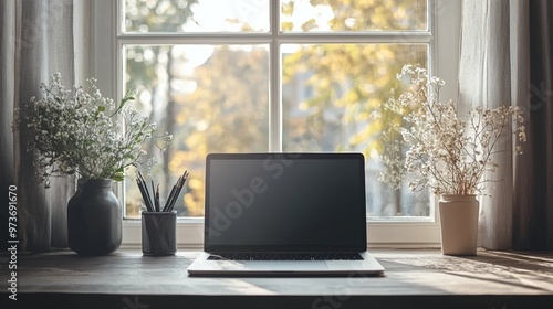 Laptop on Wooden Table by Window with Flowers