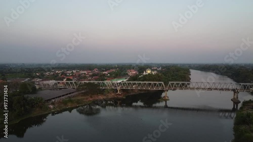 Panoramic aerial video of the Karanggeneng Bridge over the Bengawan Solo River in the afternoon.