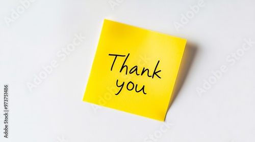 A yellow post it note with the words thank you written on it