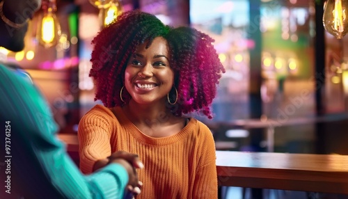 A beautiful young woman with flawless radiant skin is shaking hands with another person