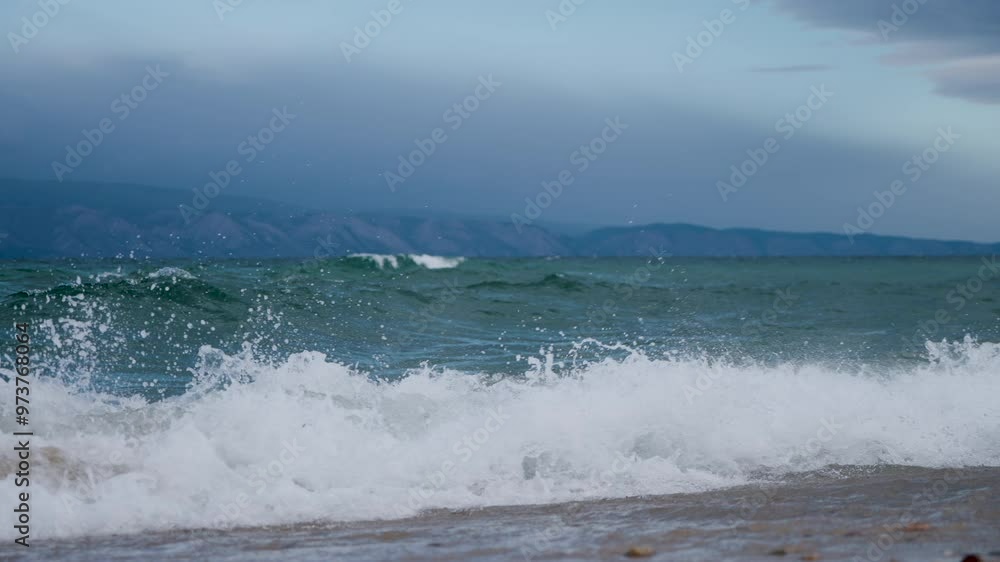 the shore of Lake Baikal with a sandy shore and small waves the shore of Lake Baikal with a sandy shore and small waves