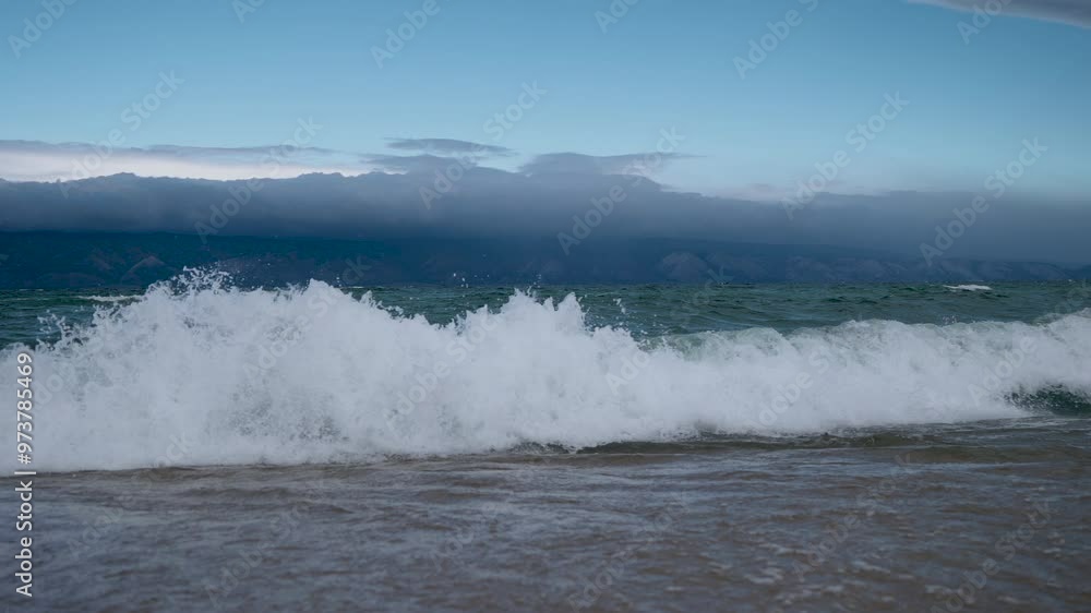 the shore of Lake Baikal with a sandy shore and small waves the shore of Lake Baikal with a sandy shore and small waves