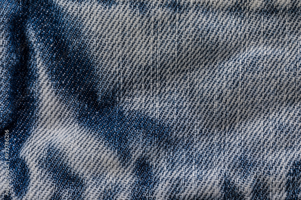 An image of close-up blue denim jeans fabric showing detailed texture with a dark blue color and a stylish design backdrop An image of close-up blue denim jeans fabric showing detailed texture with a dark blue color and a stylish design backdrop