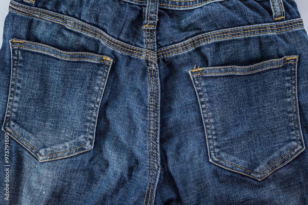 Close-up of blue denim jeans texture with a visible pocket, showcasing the fabric's intricate pattern and casual style Close-up of blue denim jeans texture with a visible pocket, showcasing the fabric's intricate pattern and casual style