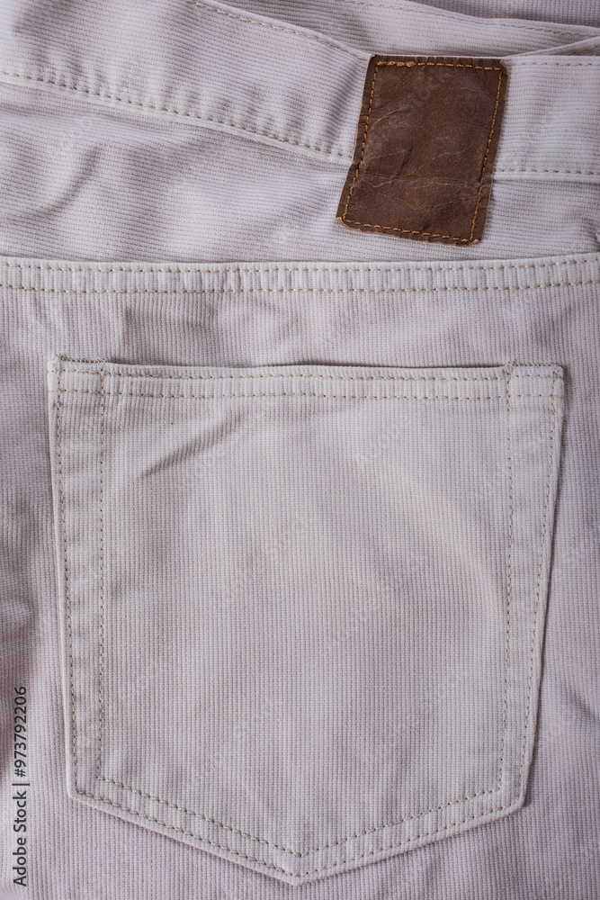 Close-up denim fabric with visible pocket and seam, textured and beige in color, perfect for casual clothing Close-up denim fabric with visible pocket and seam, textured and beige in color, perfect for casual clothing