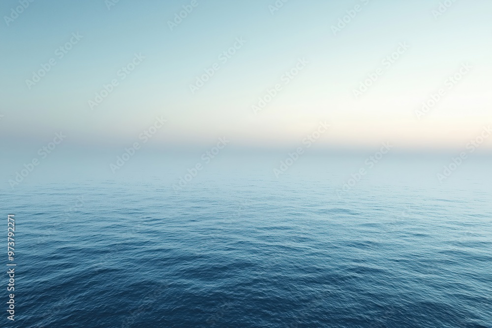 Obraz premium Calm ocean merging with foggy sky at twilight