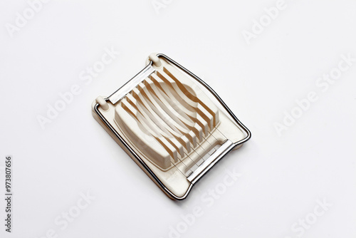 White egg slicer isolated against a white background.
