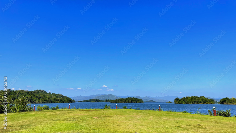 Naklejka premium A reservoir, nestled within the embrace of nature
