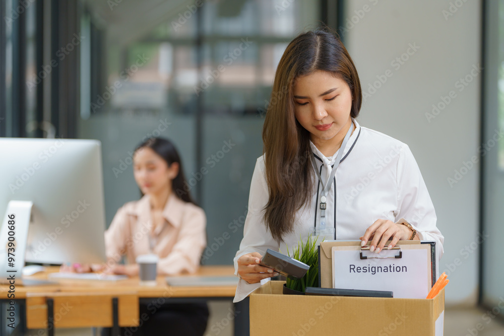 Unemployed, quiet job, desperate Asian young businesswoman resigning from company packing belongings, stuff in box cardboard, layoff or leaving, changing work. Resignation employment, dismiss concept. Unemployed, quiet job, desperate Asian young businesswoman resigning from company packing belongings, stuff in box cardboard, layoff or leaving, changing work. Resignation employment, dismiss concept.
