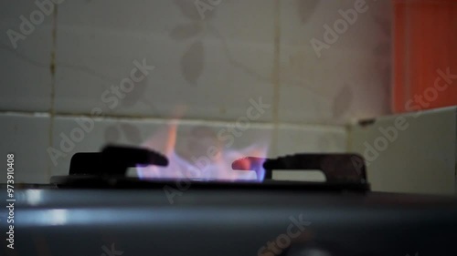 Close up of blue flames from gas stove at the kitchen photo