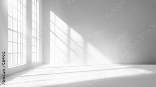 White studio background designed for product presentation, set in an empty gray room with window shadows and a blurred backdrop 