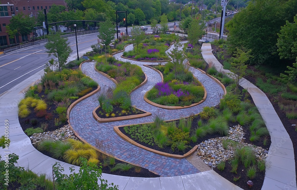 Designed to manage stormwater in an urban setting, this overhead image displays a green infrastructure project featuring permeable pavement and rain gardens. Designed to manage stormwater in an urban setting, this overhead image displays a green infrastructure project featuring permeable pavement and rain gardens.