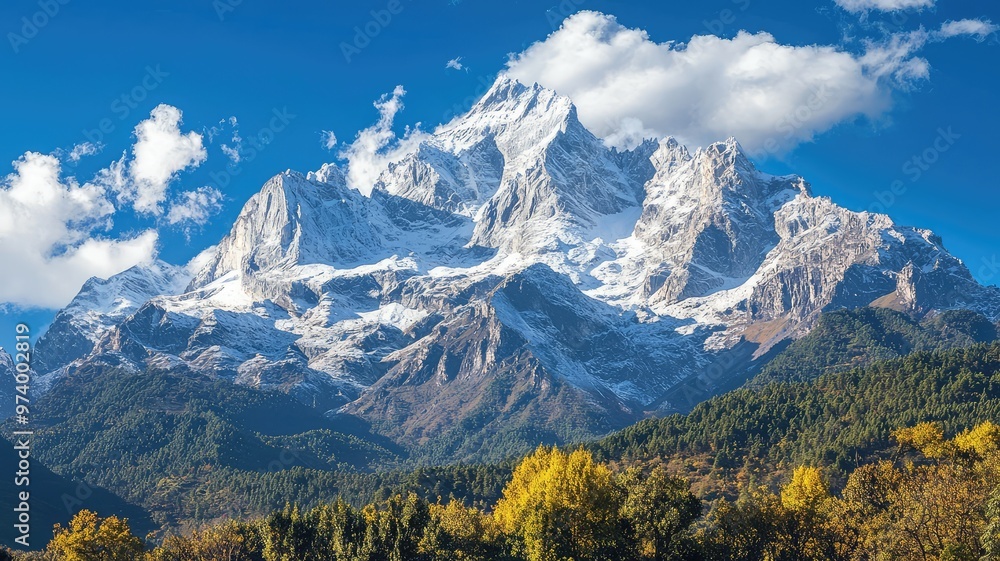 Fototapeta premium Majestic snow-capped mountain under a clear blue sky with lush greenery in the foreground, showcasing stunning natural beauty.