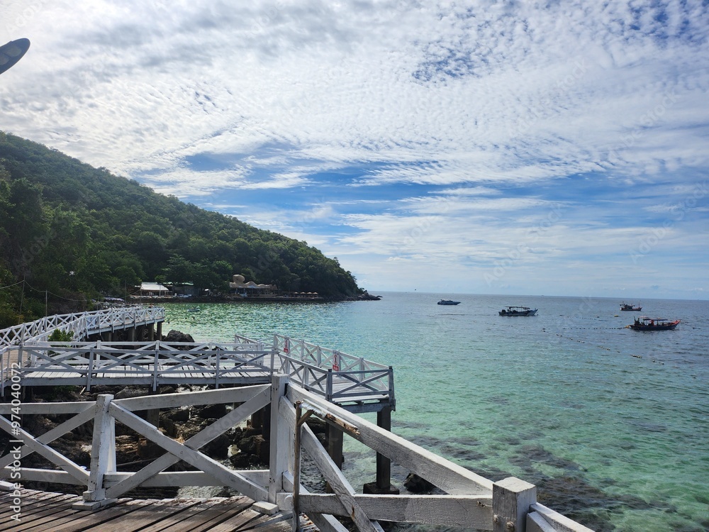 A breathtaking view of an emerald-green beach with a bridge stretching over the clear waters. The vibrant color of the sea and the calm atmosphere create a serene scene. A breathtaking view of an emerald-green beach with a bridge stretching over the clear waters. The vibrant color of the sea and the calm atmosphere create a serene scene.