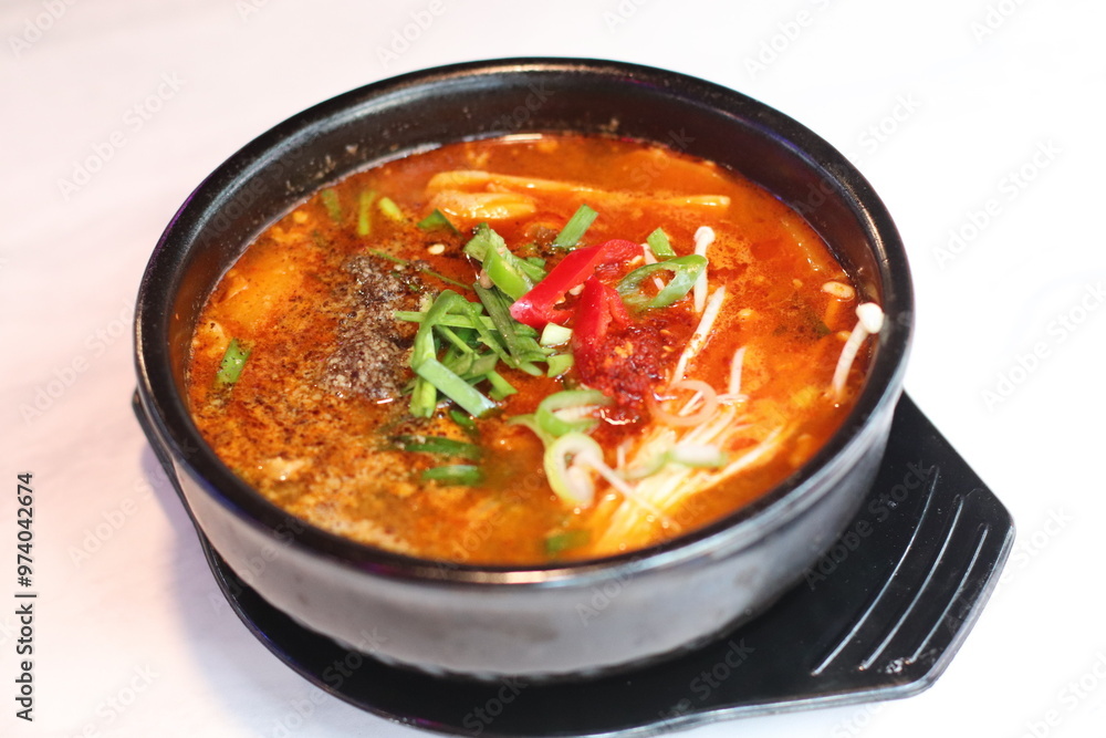 A steaming bowl of spicy Korean rice topped with vegetables and savory broth. The rich, fiery flavor is perfect for a comforting and satisfying meal. A steaming bowl of spicy Korean rice topped with vegetables and savory broth. The rich, fiery flavor is perfect for a comforting and satisfying meal.