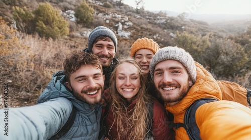 Friends selfie in a scenic camping spot, with a beautiful mountain backdrop, all smiling and happy