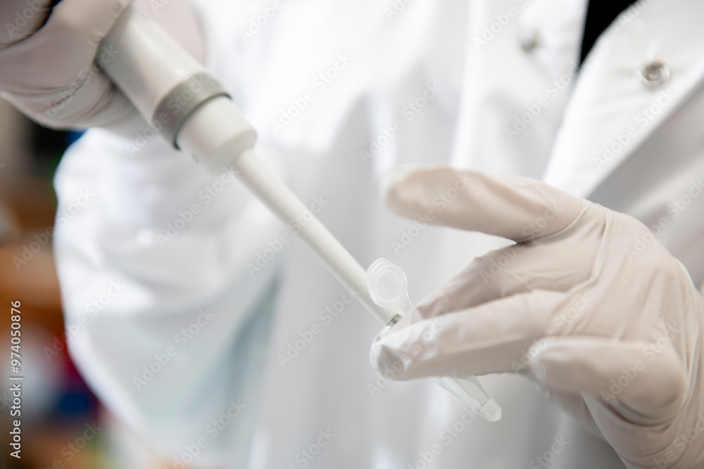 Close up of scientist pipetting into a microcentrifuge vile Close up of scientist pipetting into a microcentrifuge vile