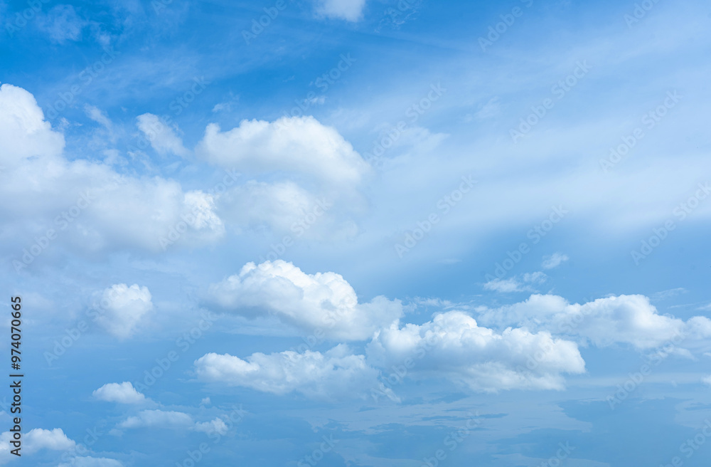 Blue Sky with Fluffy White Clouds on a Sunny Day Blue Sky with Fluffy White Clouds on a Sunny Day