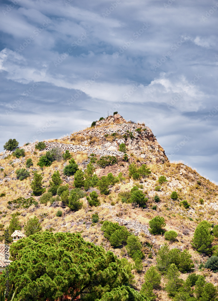 Outdoor, hill and village in nature, mountain and mockup space of sky, bush and clouds in environment. Travel, countryside and landscape of cliff, property and history of location, valley and Spain Outdoor, hill and village in nature, mountain and mockup space of sky, bush and clouds in environment. Travel, countryside and landscape of cliff, property and history of location, valley and Spain