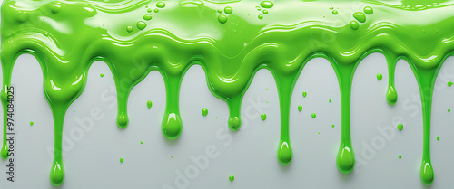 bright green slime flows evenly in drops over a white background photo