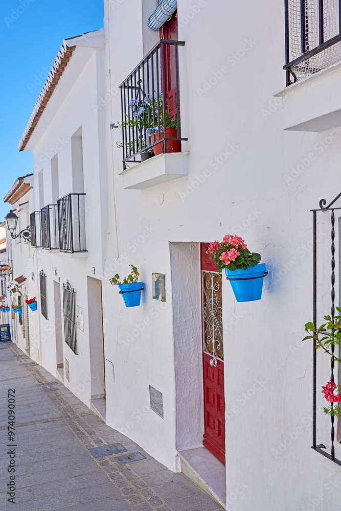 Fototapeta premium Flower pot, wall and village with architecture, landscaping and travel as texture or wallpaper. Background, nature and home garden decor for tourism, outdoor adventure or holiday destination in Spain