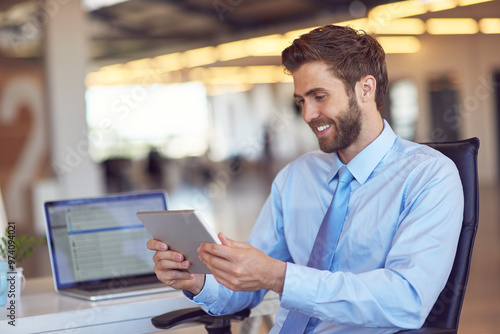 Man, business and smile on tablet at office with good news and email notification as project manager. Corporate, male person and happy or satisfied with online research, communication and networking