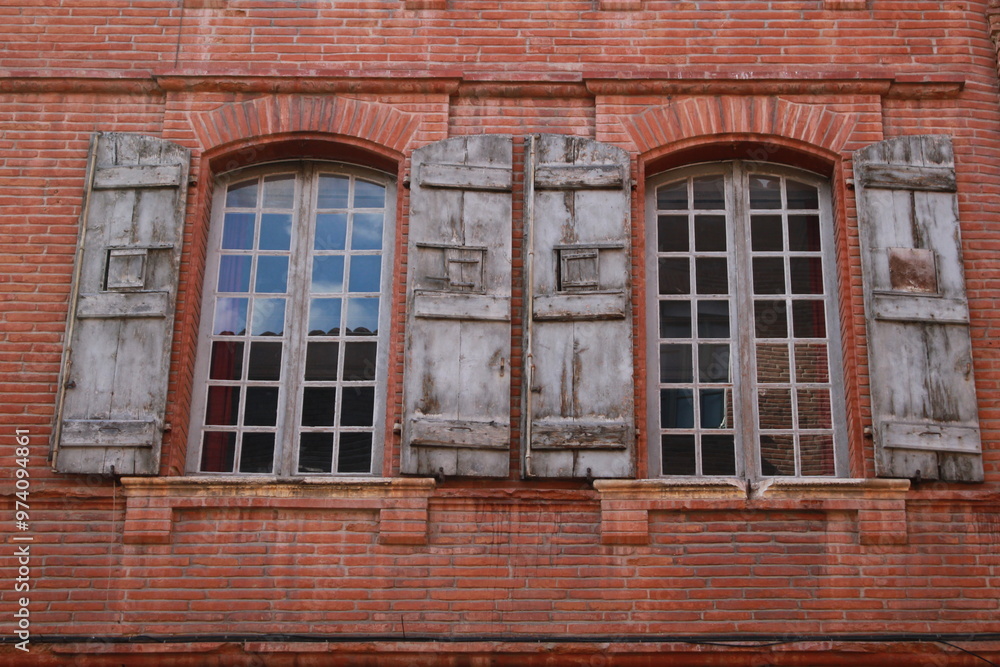 old windows in a brick wall old windows in a brick wall
