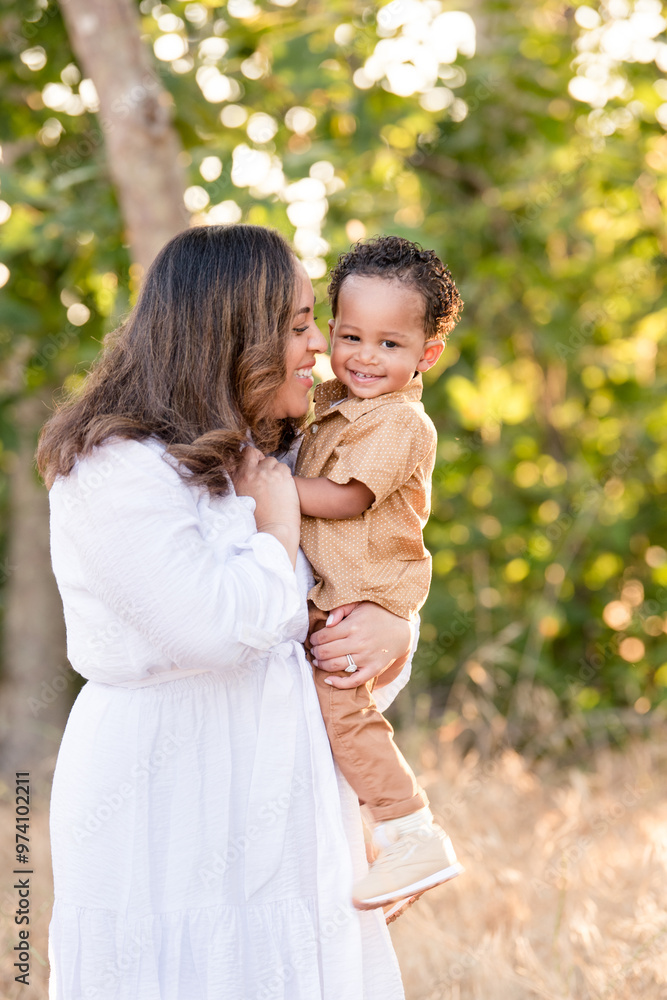 Mother holding son and smiling together Mother holding son and smiling together