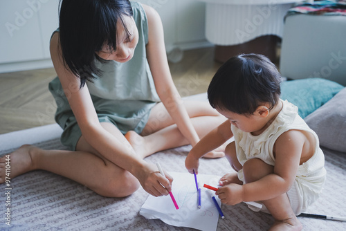 Asian woman playing with her child in the living room 