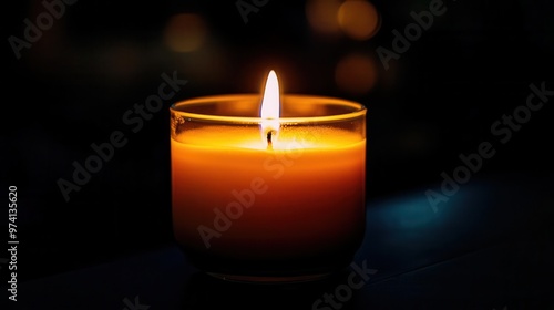 Closeup of a candle softly glowing in the dark, diffused light creating a warm ambiance, glow, intimate light