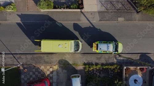 Drone. UK ambulance and ambulance car parked in an urban street. 