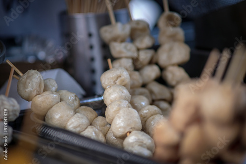 Close up of fish balls on sticks.