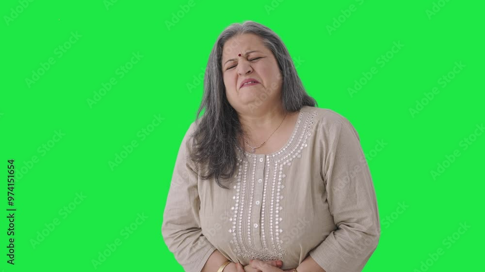 Sick Indian old woman suffering from period pain Green screen Sick Indian old woman suffering from period pain Green screen