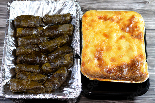 The pasta with bechamel sauce and ground minced meat and ghee cooked in the oven, Bechamel Pasta Bake (Macarona Bechamel) and wrapped grape leaves stuffed Egyptian Mahshi and filled with white rice photo