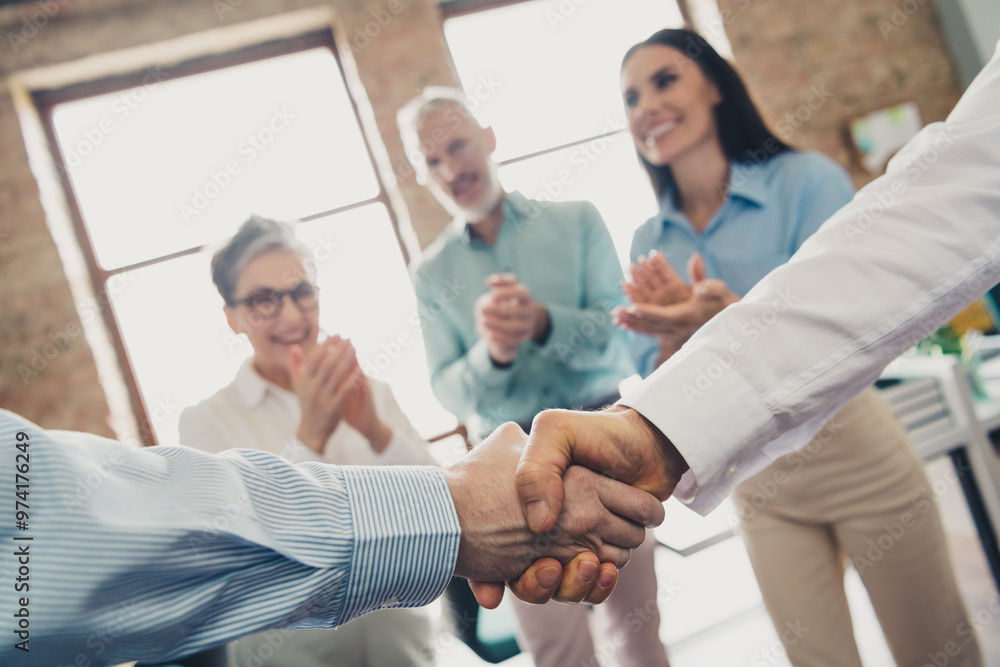 Cropped photo of teamwork startup partners shake hands deal comfortable nice creative startup office loft room interior Cropped photo of teamwork startup partners shake hands deal comfortable nice creative startup office loft room interior