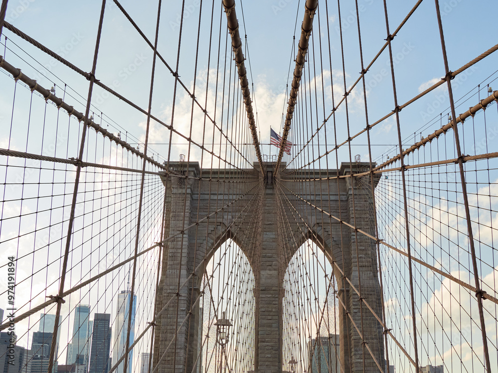 Fototapeta premium Brooklyn Bridge, connects the boroughs of Manhattan and Brooklyn in New York City. It is a historic symbol of New York and a fundamental part of the city, as it crosses the East River connecting Manha
