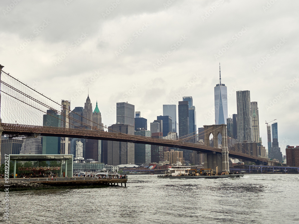 Fototapeta premium Brooklyn Bridge, connects the boroughs of Manhattan and Brooklyn in New York City. It is a historic symbol of New York and a fundamental part of the city, as it crosses the East River connecting Manha