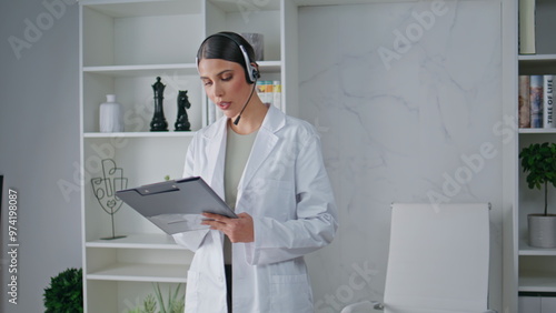 Wallpaper Mural Doctor headset reading information clipboard in medicare clinic. Woman therapist Torontodigital.ca