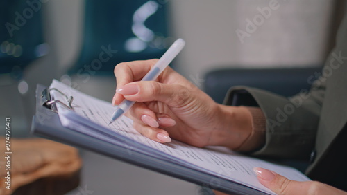 Fotografia Clinic patient hands writing medical documents in modern office closeup