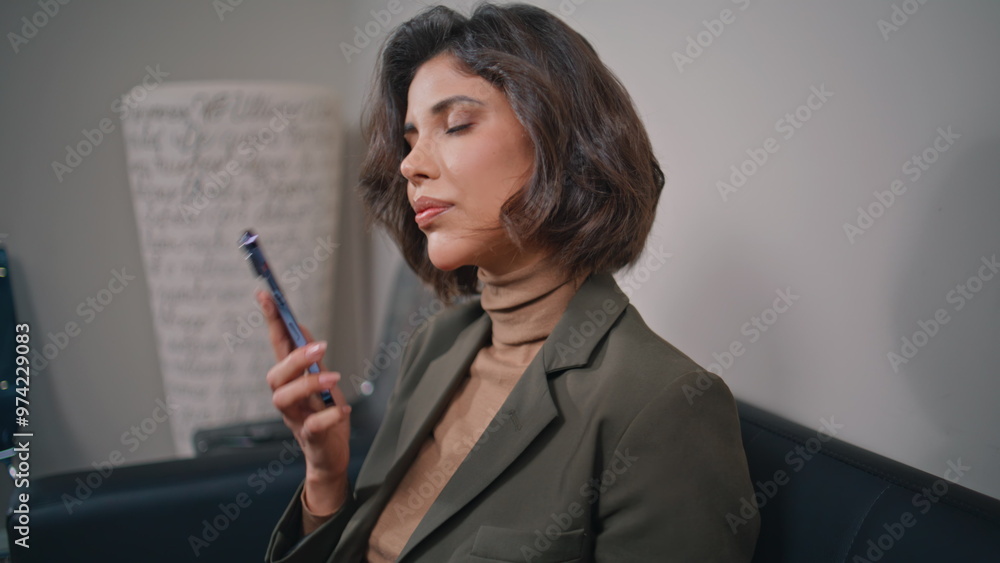 Business lady dial phone number at cellphone sitting at office interior closeup. Business lady dial phone number at cellphone sitting at office interior closeup.