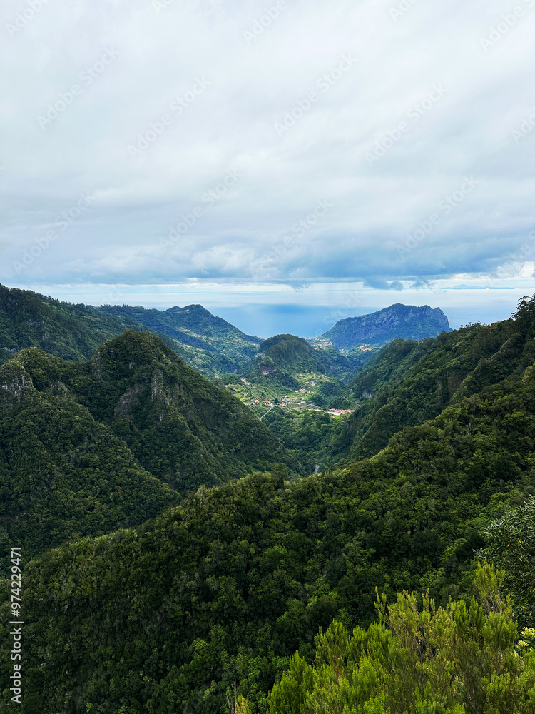 Hiking mountain trail among rocks and plants with a view of the clouds and gorge Hiking mountain trail among rocks and plants with a view of the clouds and gorge