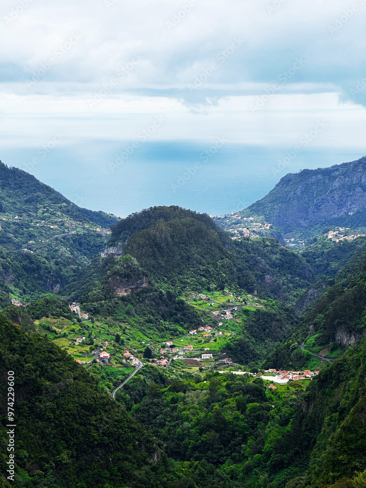 Fototapeta premium Hiking mountain trail among rocks and plants with a view of the clouds and gorge