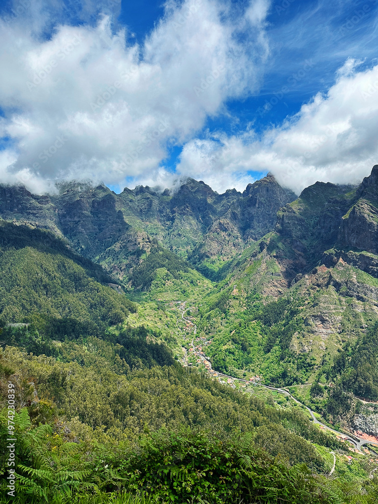 Hiking mountain trail among rocks and plants with a view of the clouds and gorge Hiking mountain trail among rocks and plants with a view of the clouds and gorge