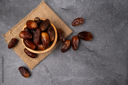 Dried date fruits in wooden bowl