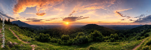 Golden sunset over a panoramic mountain landscape, with calm orange skies creating a peaceful and serene atmosphere ideal for capturing the beauty of nature and the relaxing mood of summer evenings