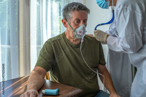 Oxygen face mask is placed on a man with breathing difficulty due to his lung disease. Covid-19, COPD, asthma and pneumonia require oxygen therapy