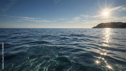 A tranquil coastal scene, with gentle waves rolling onto the shore – a scene that exudes serenity and natural beauty with partly cloudy skies and the warm glow of the rising or setting sun.