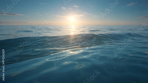 A tranquil coastal scene, with gentle waves rolling onto the shore – a scene that exudes serenity and natural beauty with partly cloudy skies and the warm glow of the rising or setting sun.