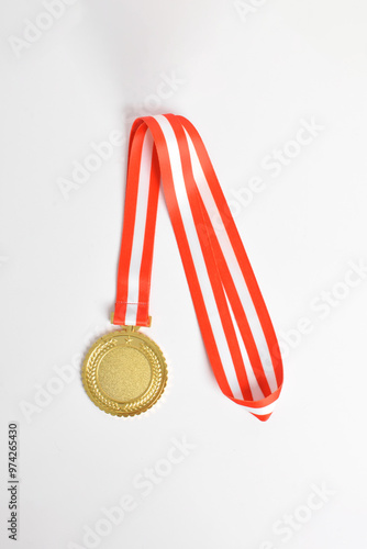 Gold medal with red and white ribbon isolated on white background. First place winner athlete. Medal for school, university or national sport competition or olympiad. Award and victory concept